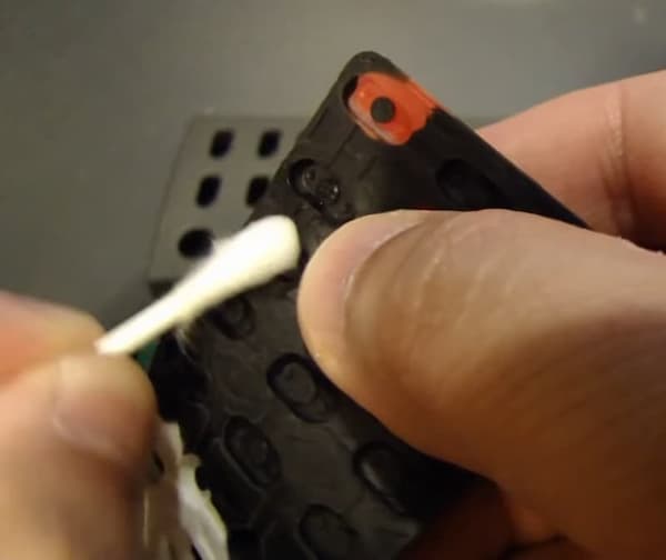 Use another Q tip dipped in alcohol to clean the inside of the Samsung TV remote's keypad