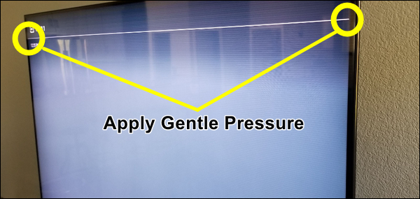 Apply gentle pressure along the edges of the TV