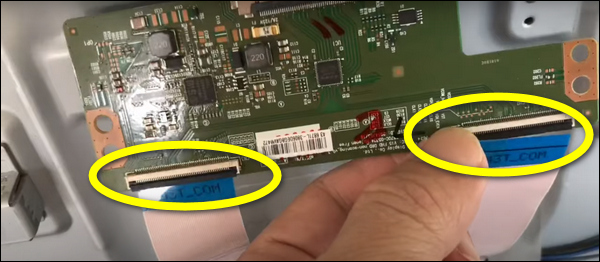 Pull the T-Con ribbon cables out of the connectors